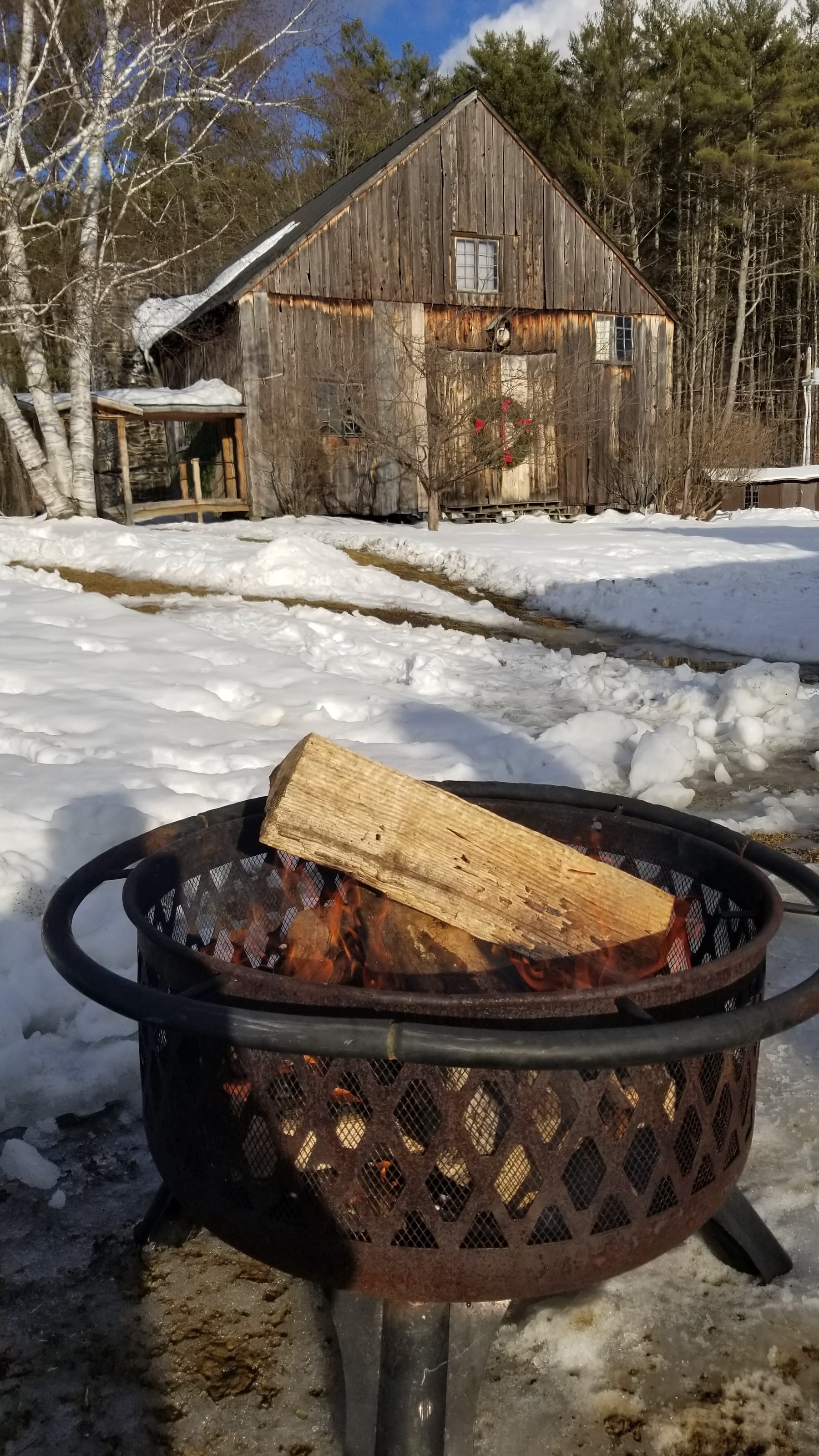 Starting an outdoor fire pit with burning wood on Saturday afternoon.