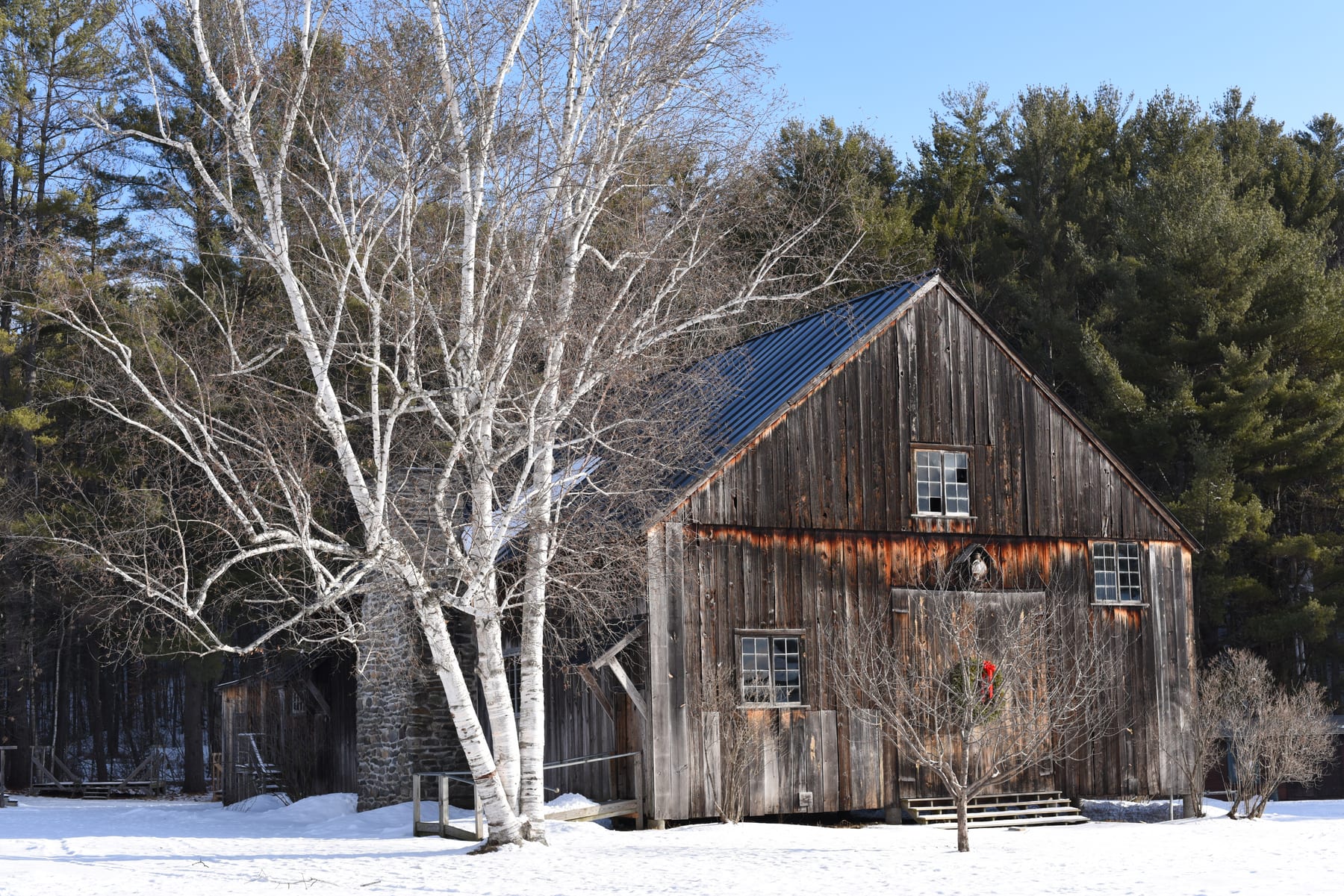 Old wooden barn in a winter landscape at the Hulbert Outdoor Center.