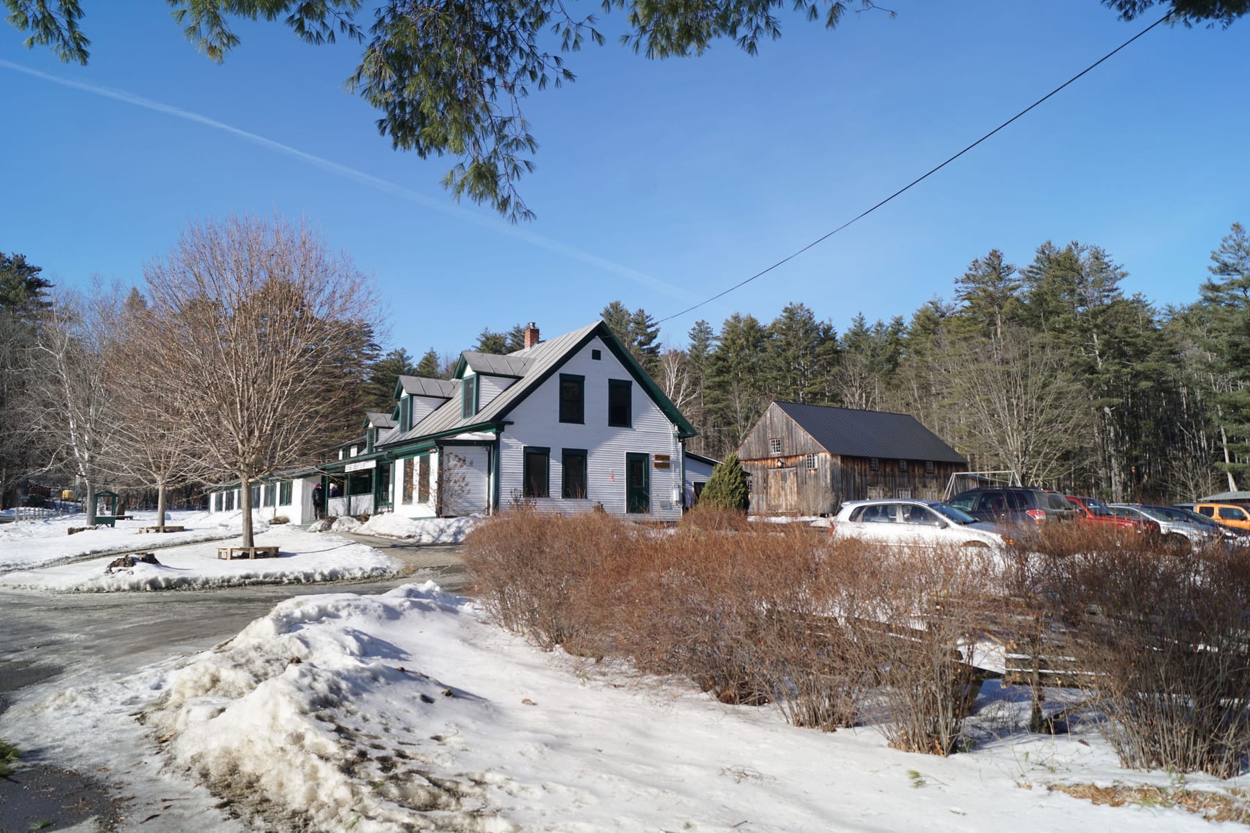 Hulbert main lodge with snow-covered grounds and parked cars.