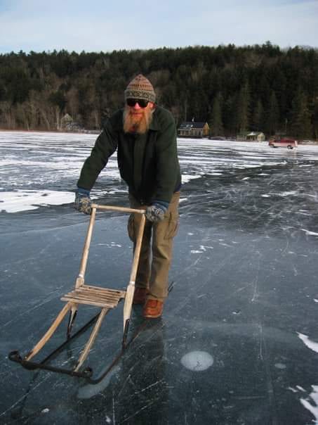 Frank on a kick sled enjoying the smooth ice on Lake Morey