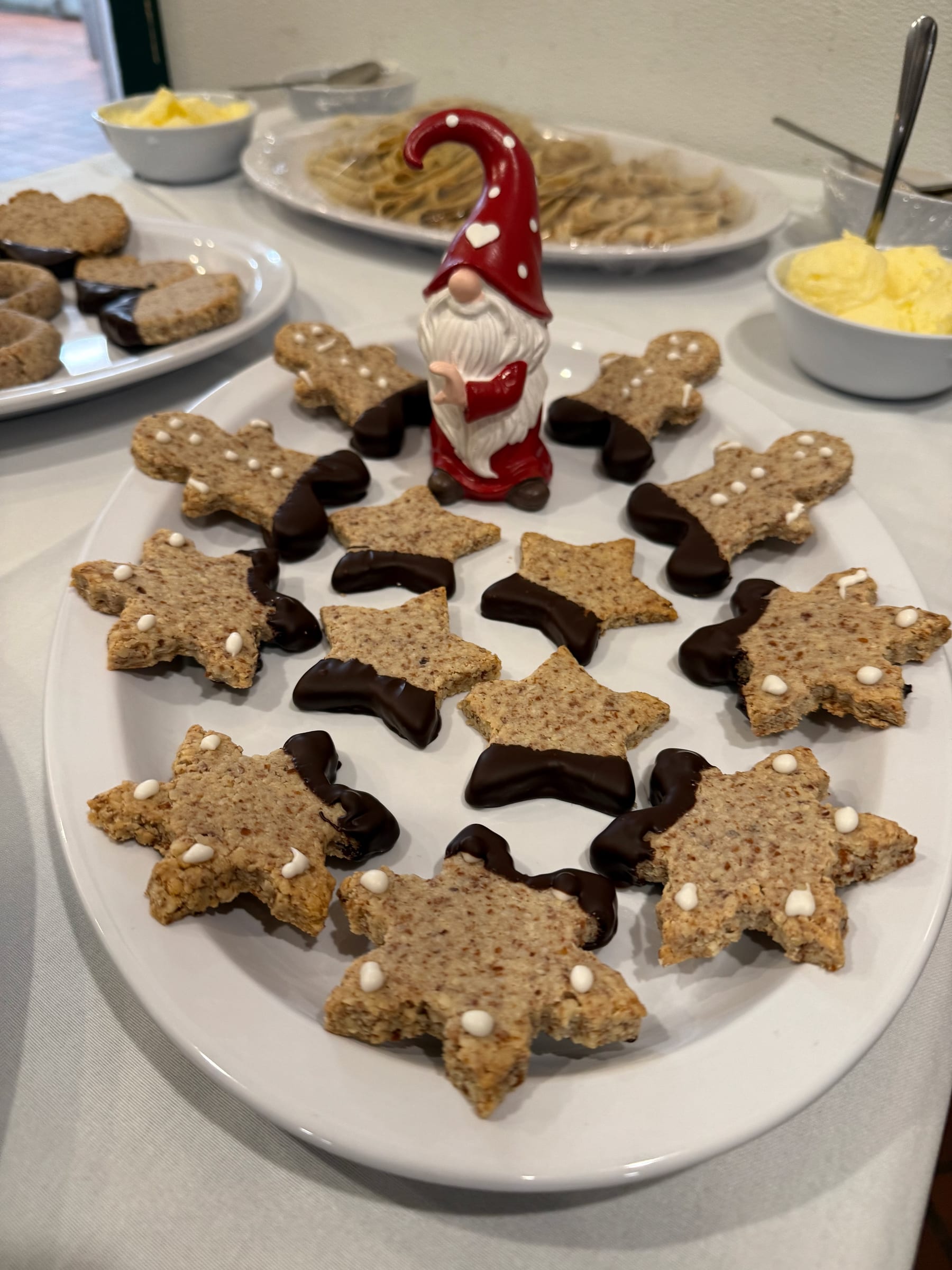 A 'love nisse (gnome)' guards a plate of chocolate dipped cookies.