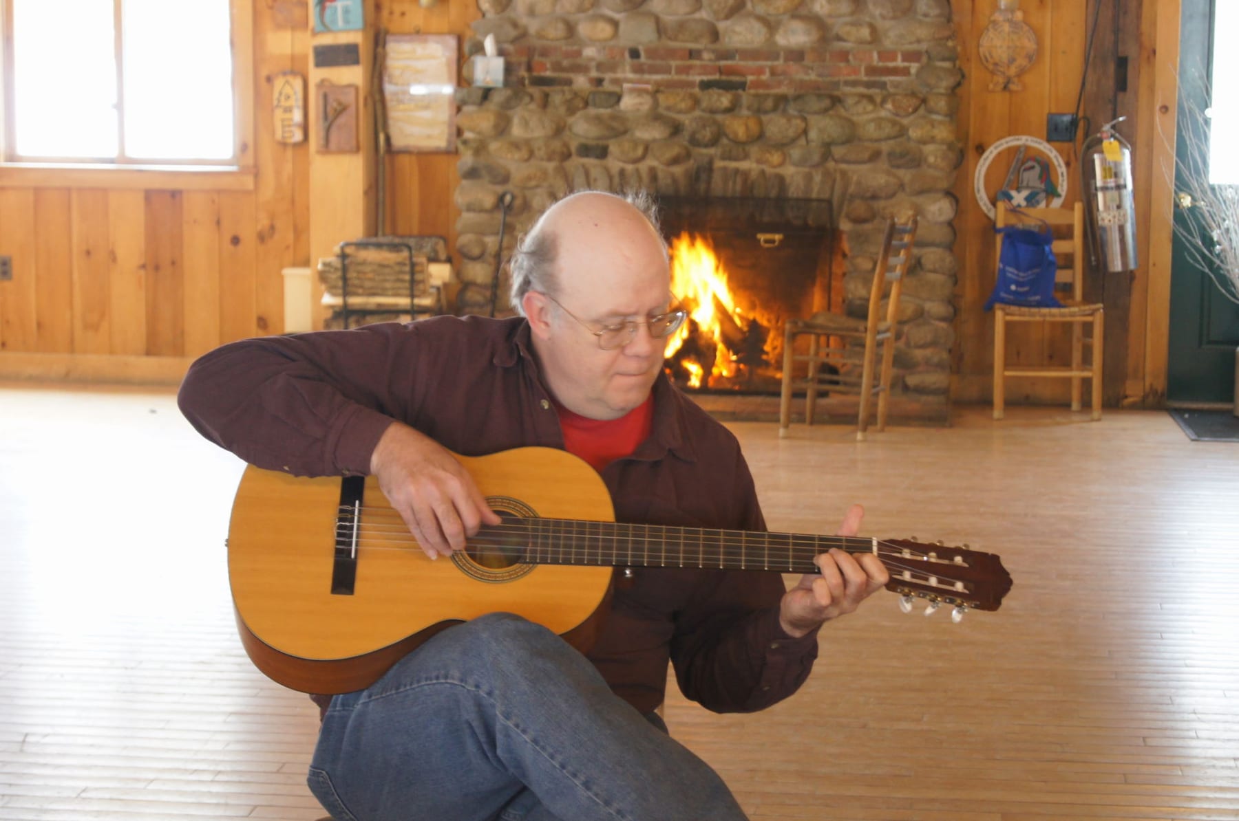 Bruce Emory playing guitar during Sunday morning breakfast. Relaxing and soothing after a long night dancing fiddling and partying!